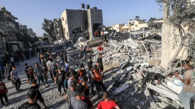Palestinians evacuate wounded after an Israeli airstrike in Rafah refugee camp^ southern Gaza Strip^ on October 13 2023.
