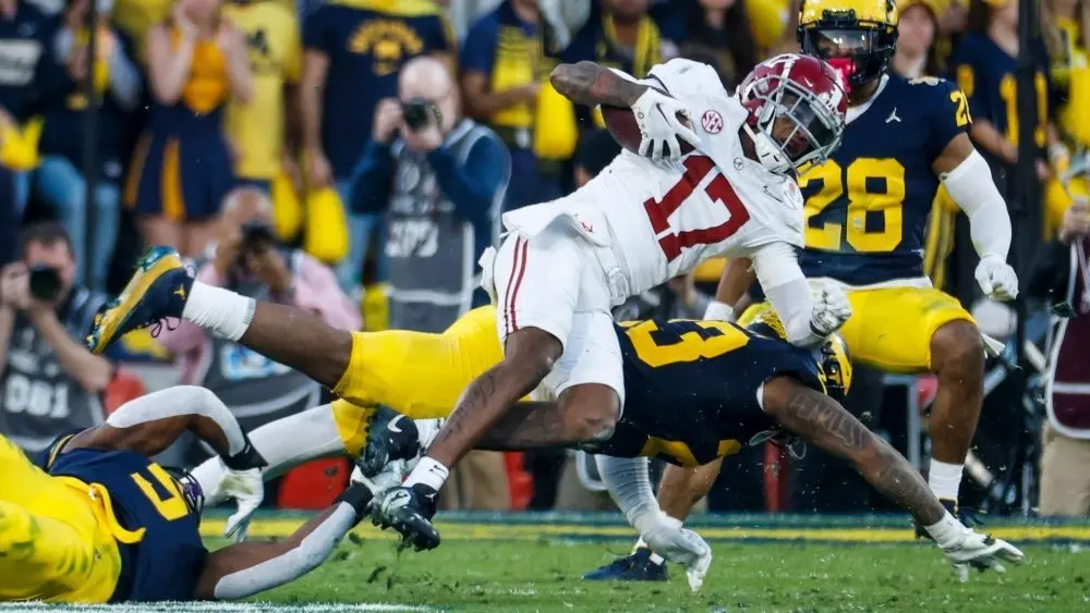 Alabama wide receiver Isaiah Bond (R)is tackled during the 2024 Rose Bowl game Monday^ Jan. 1^ 2024^ in Pasadena^ Calif.