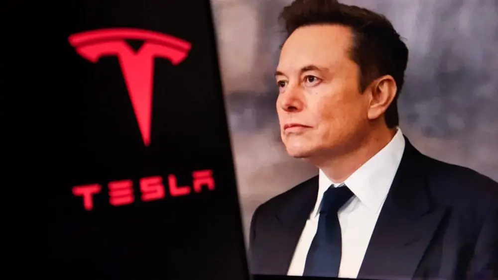 Elon Musk^ CEO of Tesla^ in a formal suit with the Tesla logo in the background. The image depicts electric vehicles^ innovations^ and tech leadership.