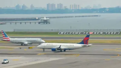 : Delta Airlines and American Eagle planes seen at the runway of LaGuardia International Airport. Manhattan^ New York^ USA - August 5^ 2025