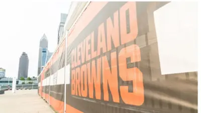Cleveland Brown's Banner Closeup Leading To The Structural Cityscape Skyline Of Downtown Cleveland. Cleveland^ Ohio/USA - June 1^ 2019