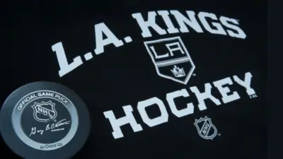 Official NHL game puck with LA kings equipment ^ product shot