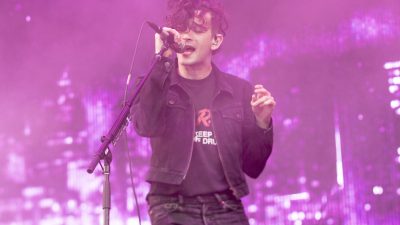 The 1975 singer Matty Healy performing