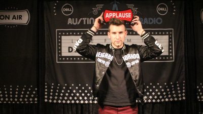 Max Frost holding up applause sign at Dell Music Lounge