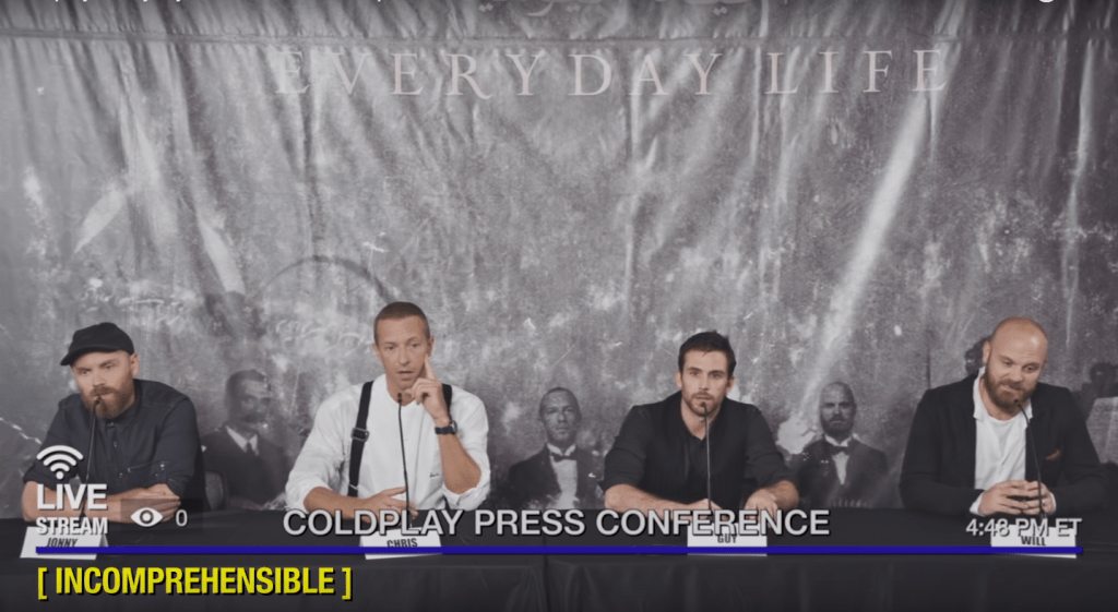 coldplay sitting in mock press conference