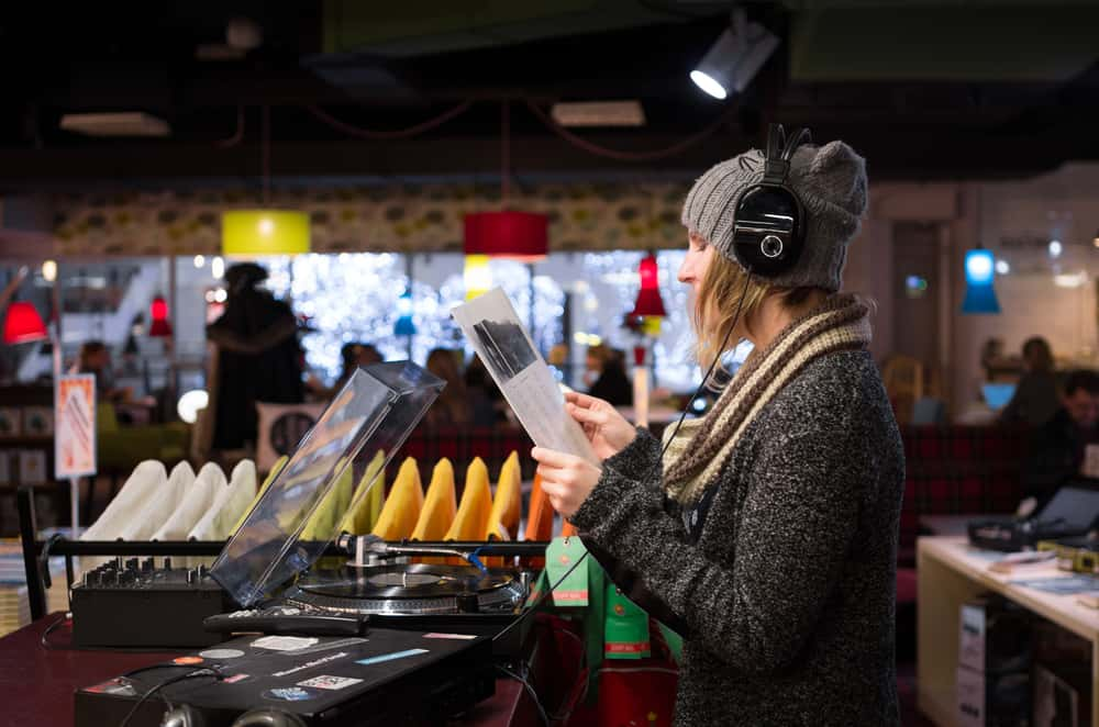 Woman listening to records in record store