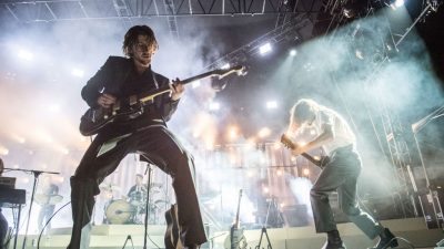Arctic Monkeys performing on stage
