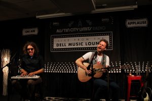 Hiss Golden Messenger singing while playing guitar