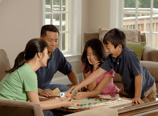 family playing board game