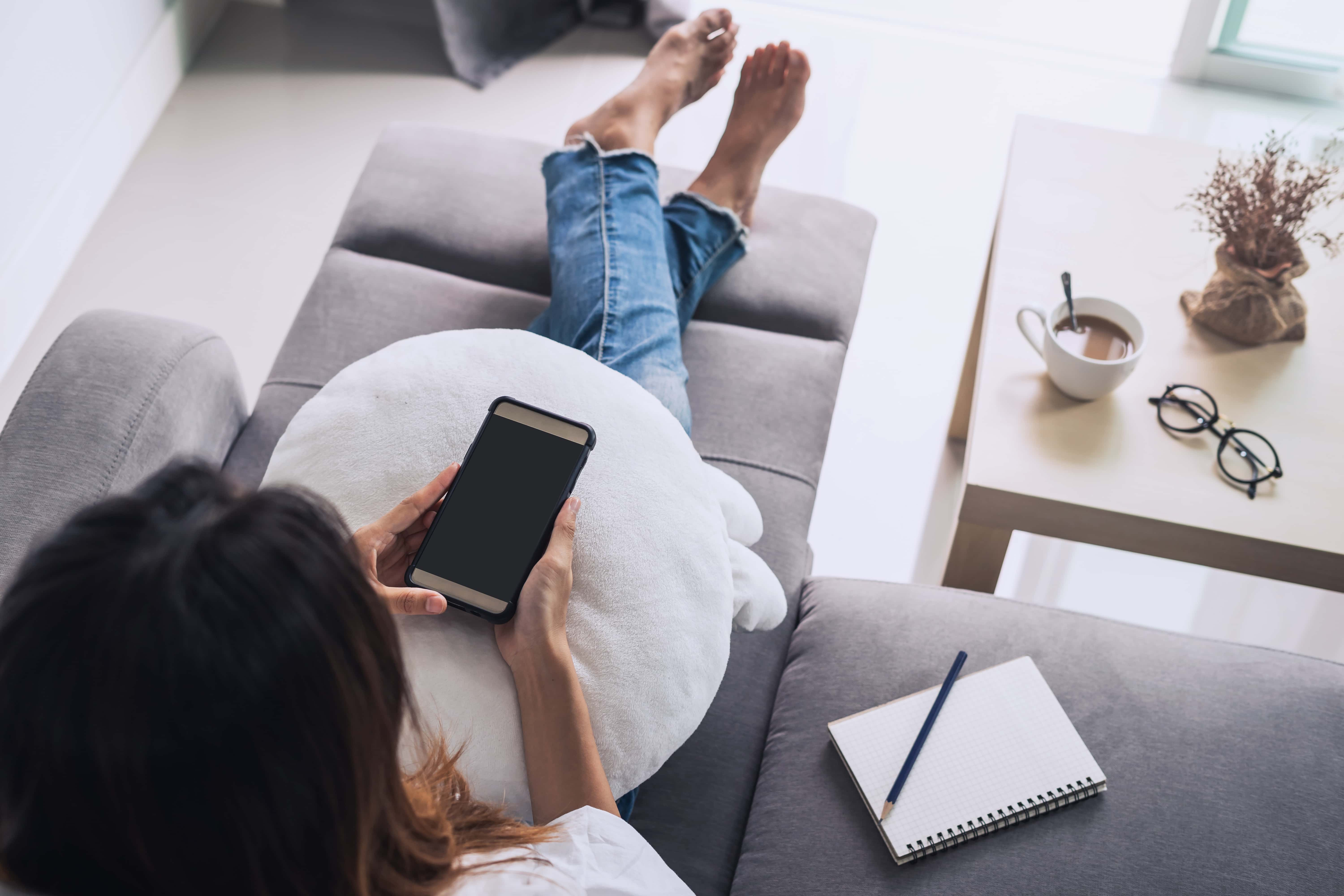 person on the couch using phone