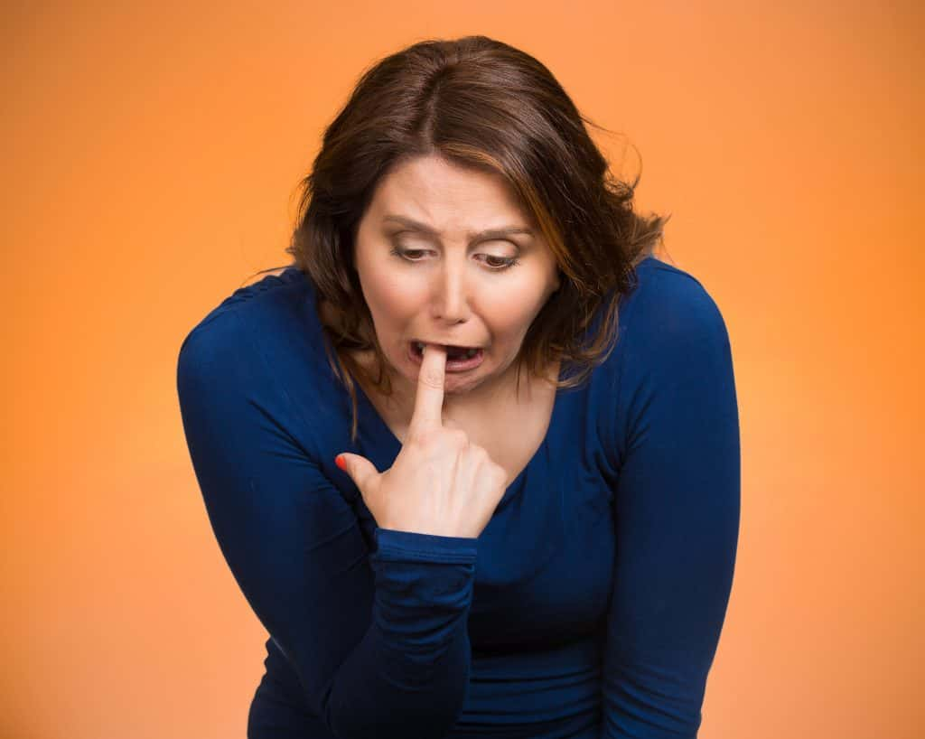 A lady pretending to puke.