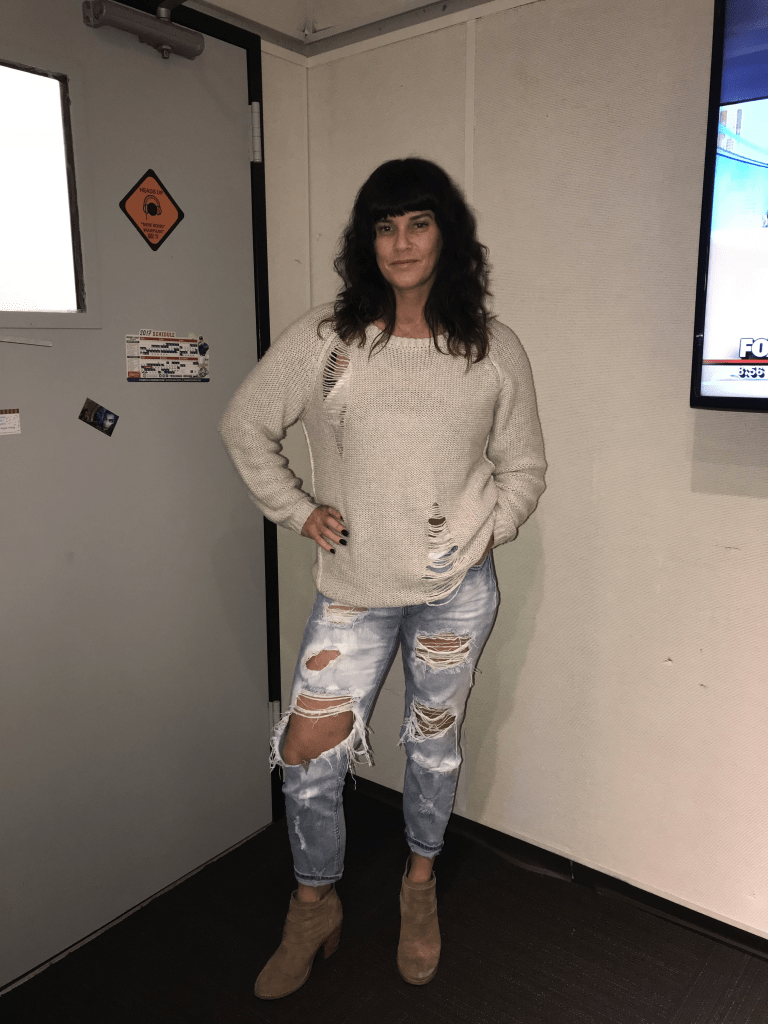 Deb O'Keefe showing off her very holey jeans and sweater outfit.