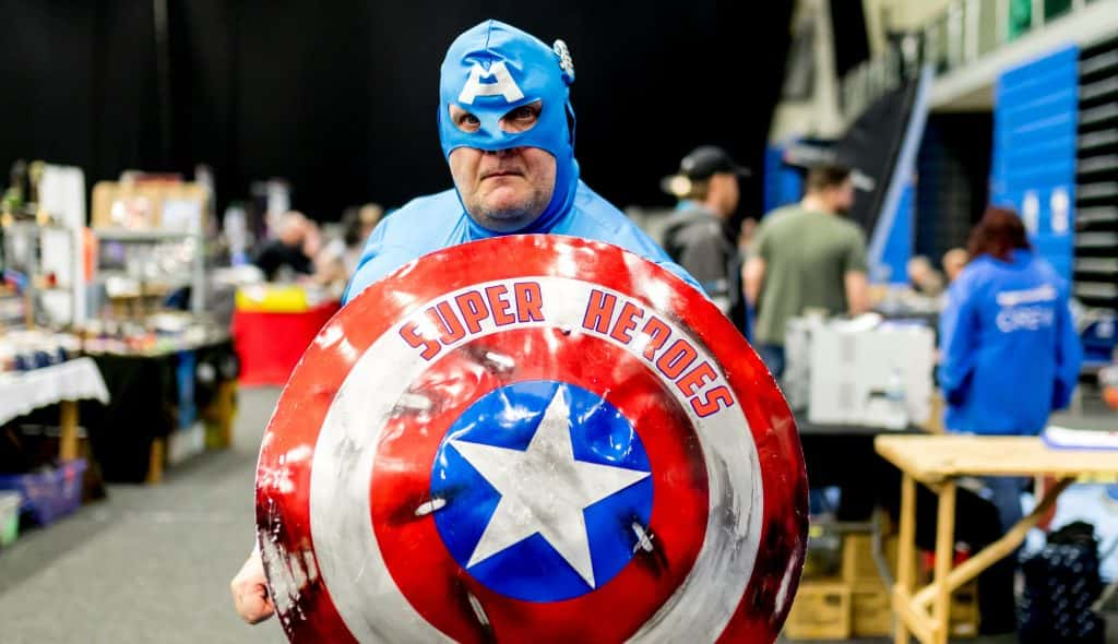 A guy with a captain America shield and suit.