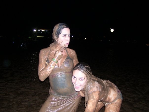 two girls wearing dresses and covered in mud