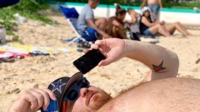 Jason laying on the sand in Hawaii.