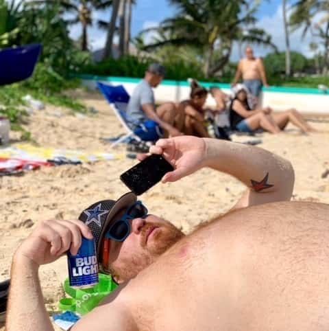 Jason laying on the sand in Hawaii.