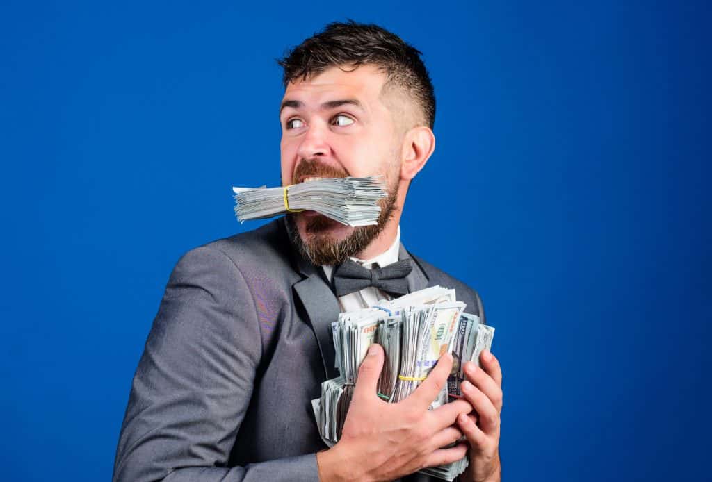 A guy hoarding a wad of cash.
