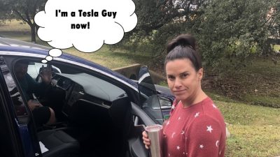 Deb in front of Jason's Tesla.