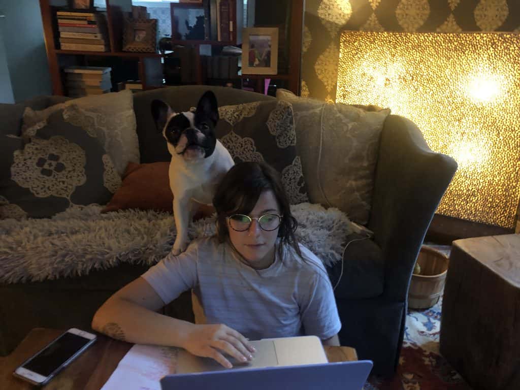 producer katy trying to do her fantasy football draft while Deb's dog Alfie distracts her