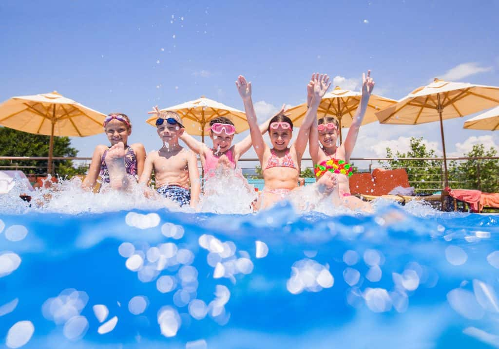 Kids splashing in a pool.