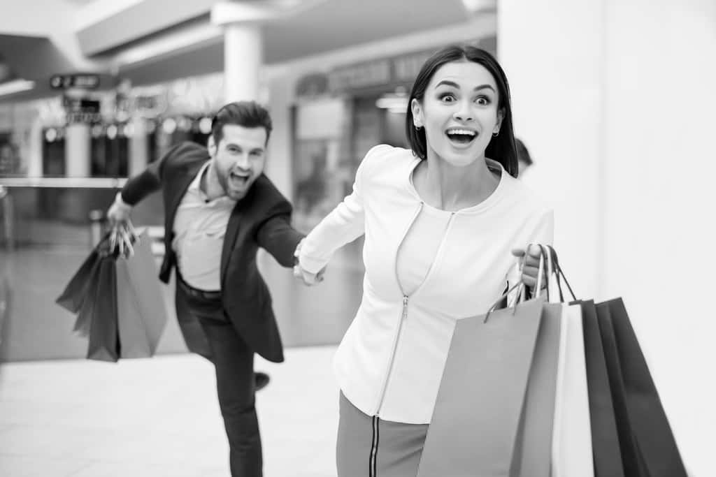 Lady and man running with shopping bags.