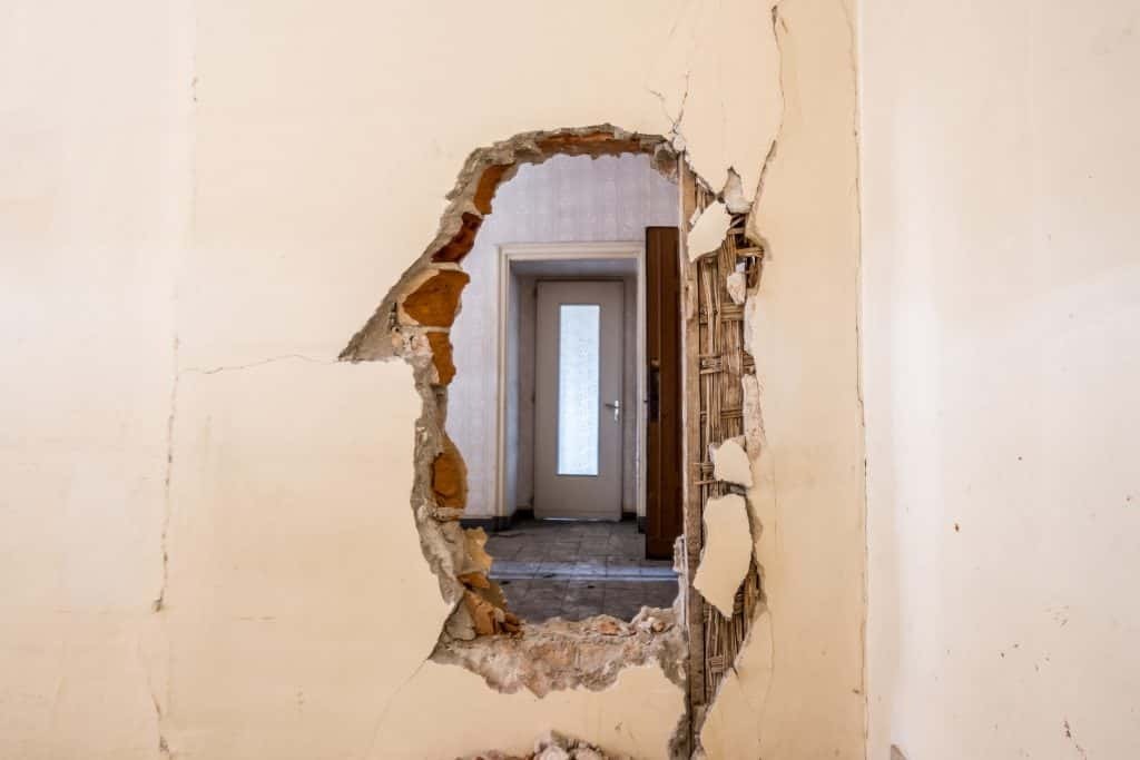 Kitchen demolition hole in wall.