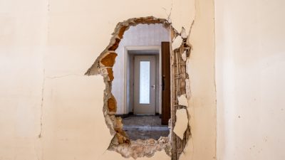 Kitchen demolition hole in wall.