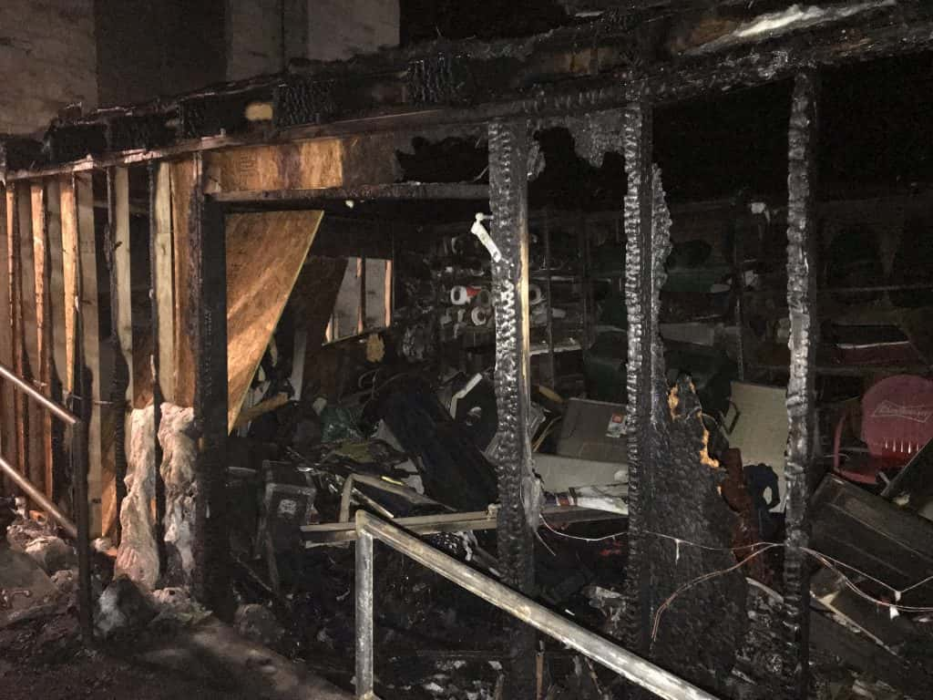 the burned out remains of the storage shed behind the radio station