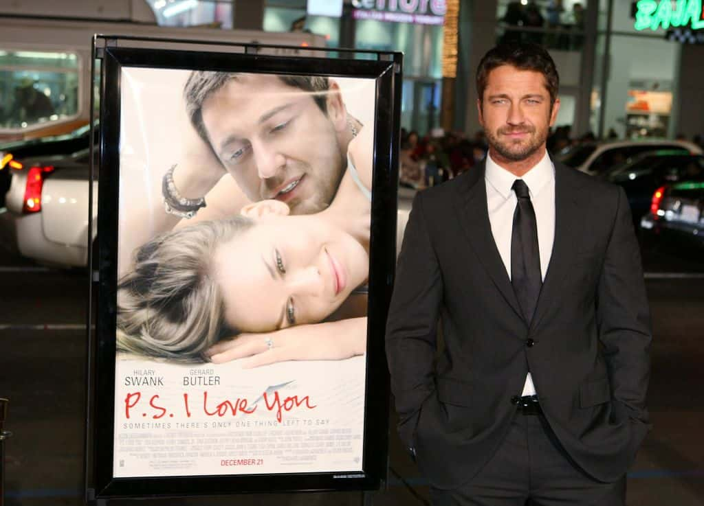 Gerard Butler in front of P.S. I Love You Poster