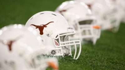 The Texas Longhorns helmets are arranged on the field
