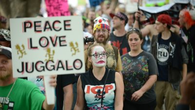 a fan of ICP with a peace love juggalo sign