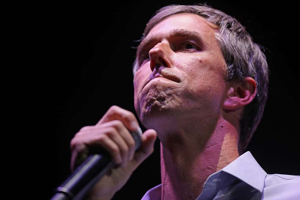 Beto O'Rourke holding the microphone at the very top during his Senate race concession speech