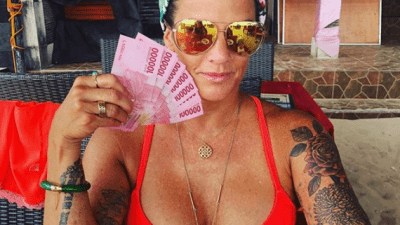 Deb Okeefe on vacation in Bali holding 1.2 million in Indonesian Rupiah