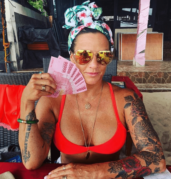 Deb Okeefe on vacation in Bali holding 1.2 million in Indonesian Rupiah