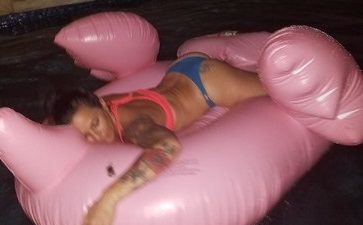 Deb on a flamingo tan in the pool.