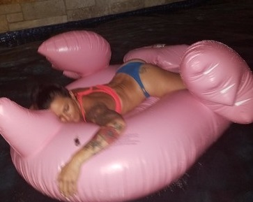Deb on a flamingo tan in the pool.