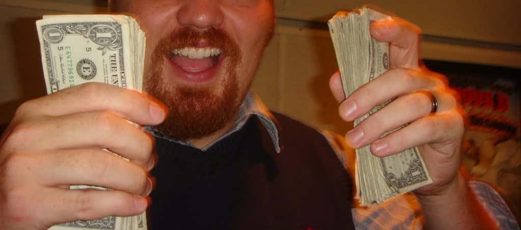 Photo of Jason holding cash in the old 101X studio.