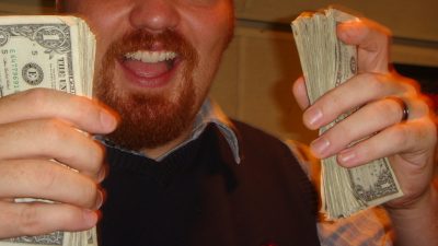 Photo of Jason holding cash in the old 101X studio.