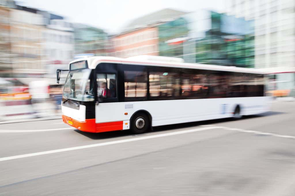 A bus moving fast in a city.