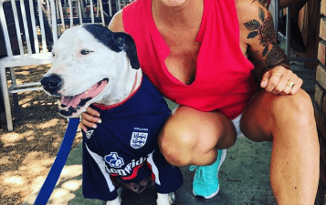 Image of Deb and Blue in a Bar with red shirt to represent England and a dog jersey for blue