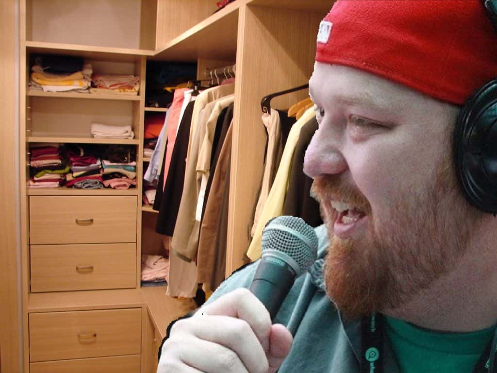 Jason in the closet with a microphone and headphones.