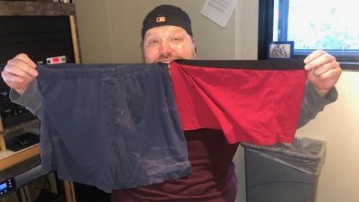 Jason holding up two versions of underpants.