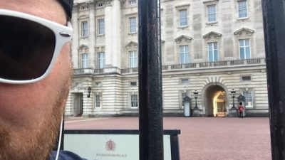 Jason with sun glasses in front of a building in Europe.