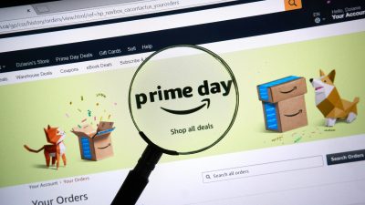 Amazon prime day page on official amazon site under magnifying glass.
