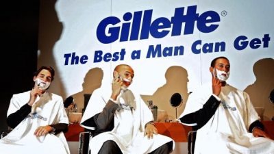 Gillette the best a man can get three sign with three men shaving.