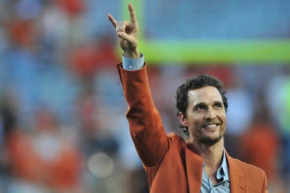 Matthew McConaughey puts his horns up before kickoff between the Texas Longhorns and Iowa State Cyclones