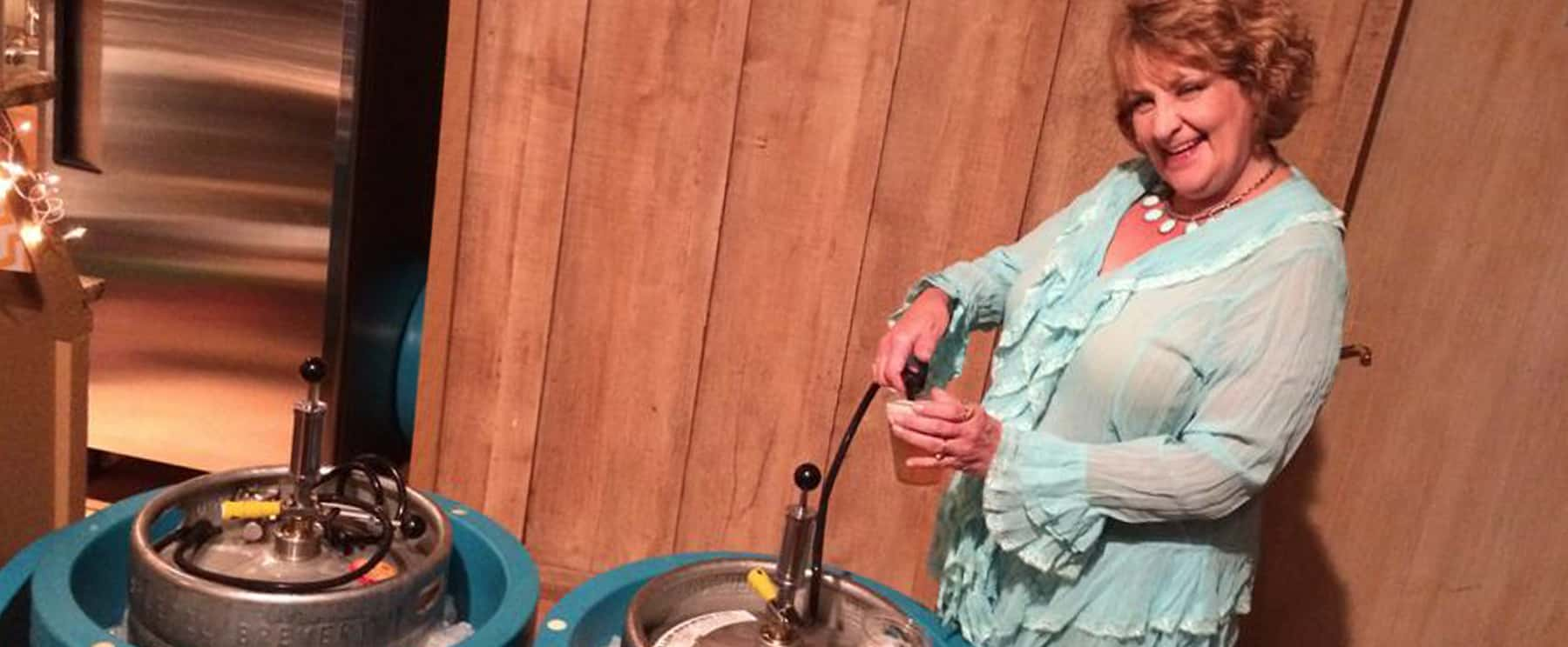 a woman pumping a keg