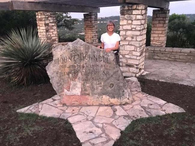 Nick's Mom in front of the Mount Bonnell sign.