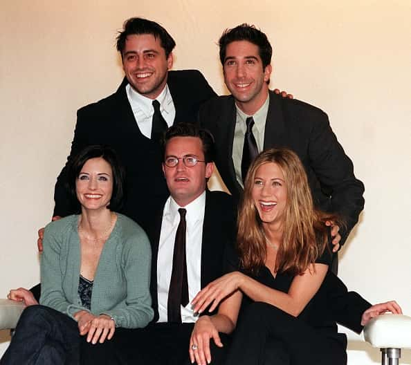 The cast of the American sitcom Friends laughing and smiling.