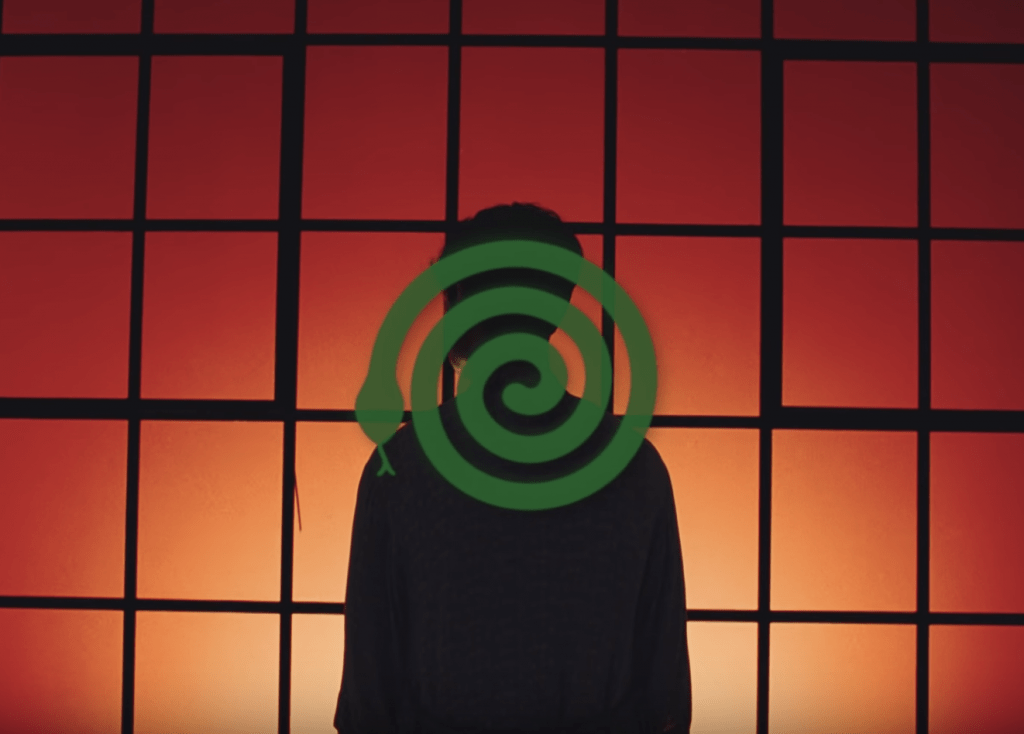 Green animated snake making a spiral on top of a background with a man's silhouette